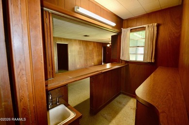 Welcome to a rare bayou-front opportunity offering privacy