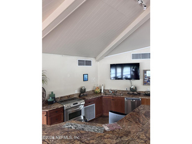 This 950-square-foot, two-bedroom, two-bath end unit sits in the - photo 18