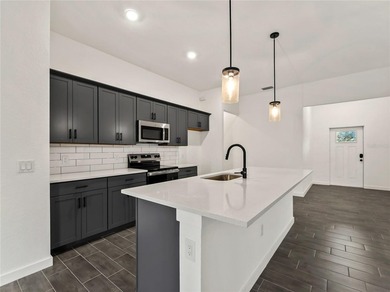 Tile throughout. Quartz countertops. Impact windows. Paver - photo 5