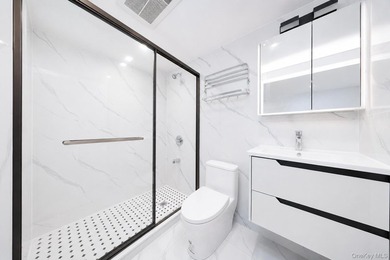 Welcome to this beautifully renovated two family home in the - photo 14
