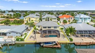 Welcome to your coastal paradise! This ELEVATED canal home with - photo 1