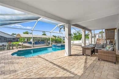 Welcome to your coastal paradise! This ELEVATED canal home with - photo 5