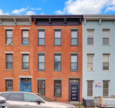 This attractive triplex has a beautifully restored facade that - photo 1