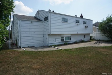 This split-level home in Lindenhurst features four spacious - photo 3