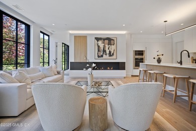 This impressive home has floor-to-ceiling windows, wood floors