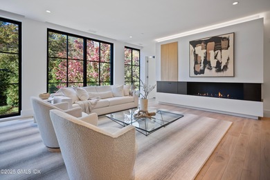 This impressive home has floor-to-ceiling windows, wood floors