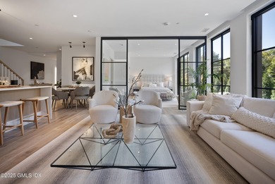 This impressive home has floor-to-ceiling windows, wood floors