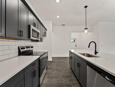 Tile throughout. Quartz countertops. Impact windows. Paver - photo 3