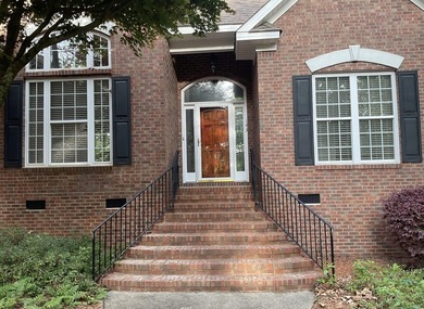 The expressive brick entrance staircase invites you into a well - photo 3