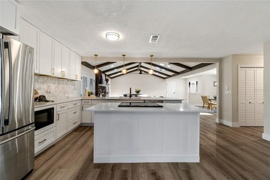 Inside, the home has been thoughtfully updated with an open - photo 6