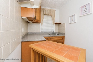 Located at 1879 Haring Street, this full brick end-unit - photo 21