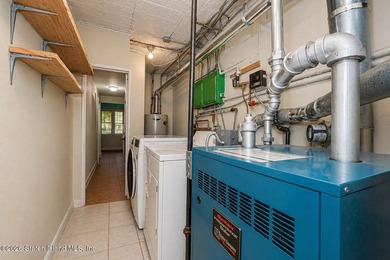 Located at 1879 Haring Street, this full brick end-unit - photo 23