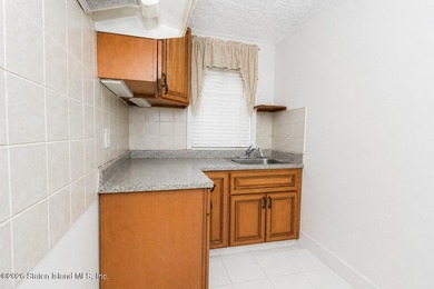 Located at 1879 Haring Street, this full brick end-unit - photo 29