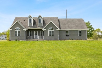 Tucked off the road on 4 peaceful acres, this 2005 custom ranch - photo 1