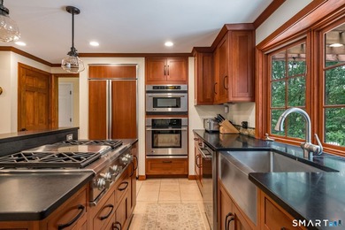 Set gracefully on a beautifully landscaped property framed by - photo 12