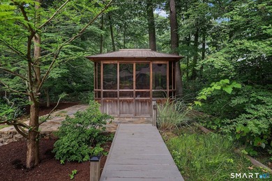 Set gracefully on a beautifully landscaped property framed by - photo 33