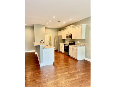 The spacious, open floor plan includes hardwood flooring, gas - photo 11