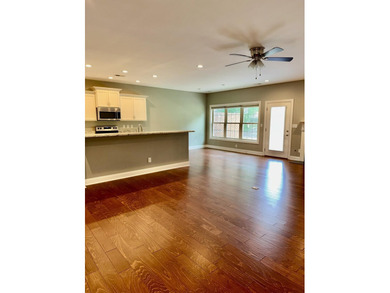 The spacious, open floor plan includes hardwood flooring, gas - photo 14