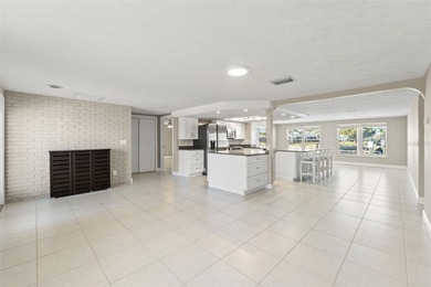 This beautifully updated Gulf Harbors waterfront home delivers