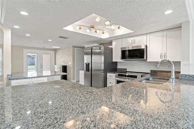 This beautifully updated Gulf Harbors waterfront home delivers