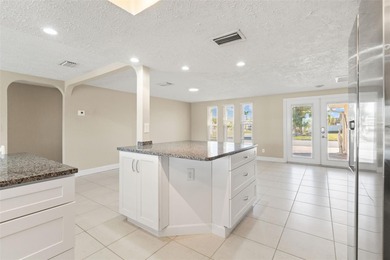 This beautifully updated Gulf Harbors waterfront home delivers