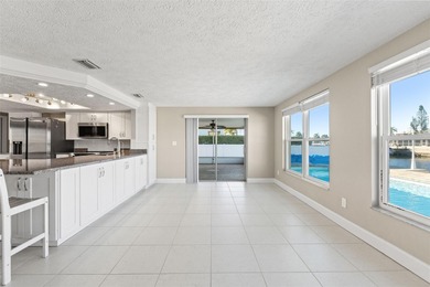This beautifully updated Gulf Harbors waterfront home delivers
