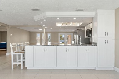 This beautifully updated Gulf Harbors waterfront home delivers