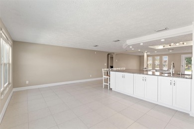 This beautifully updated Gulf Harbors waterfront home delivers