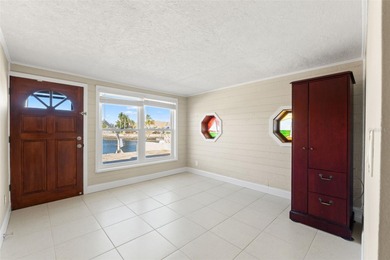 This beautifully updated Gulf Harbors waterfront home delivers