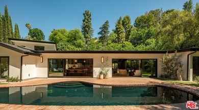 Tucked behind gates in prime Encino, this warm organic-modern - photo 1