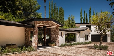 Tucked behind gates in prime Encino, this warm organic-modern - photo 2