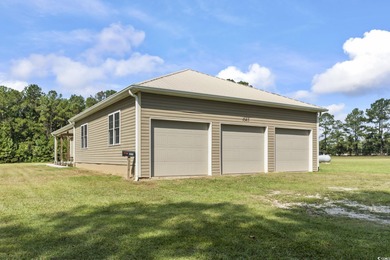 Set on 10.23 cleared acres in Loris, SC, this remarkable estate