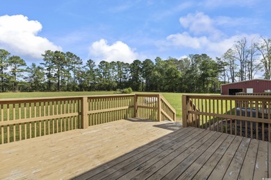 Set on 10.23 cleared acres in Loris, SC, this remarkable estate