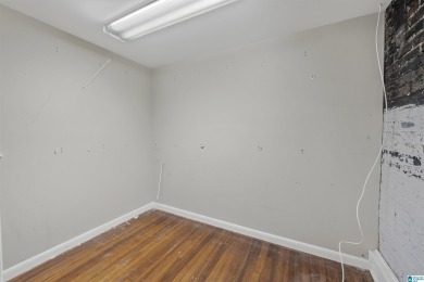 Exposed brick wall, floor to ceiling windows, exposed cedar