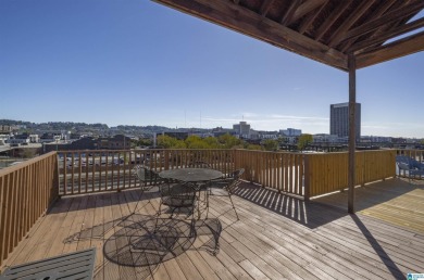 Exposed brick wall, floor to ceiling windows, exposed cedar