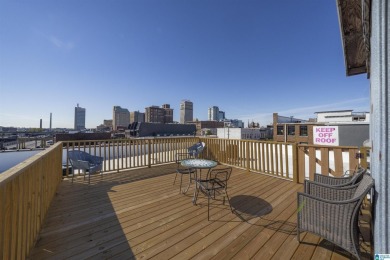 Exposed brick wall, floor to ceiling windows, exposed cedar