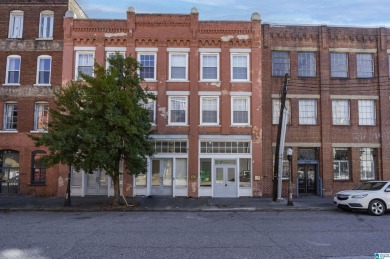 Exposed brick wall, floor to ceiling windows, exposed cedar