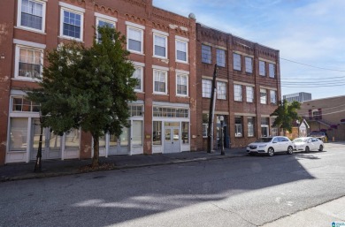 Exposed brick wall, floor to ceiling windows, exposed cedar