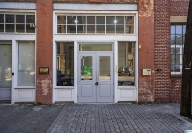 Exposed brick wall, floor to ceiling windows, exposed cedar