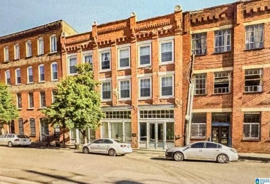 Exposed brick wall, floor to ceiling windows, exposed cedar