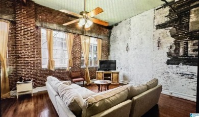 Exposed brick wall, floor to ceiling windows, exposed cedar