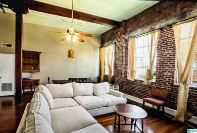 Exposed brick wall, floor to ceiling windows, exposed cedar