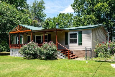 Enjoy lakefront living with this 3 bedroom, 2 bath home, sitting - photo 1