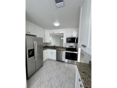 Updated Corner 3 bdr 2 bth plus den Villa. White wood kitchen - photo 3