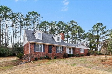 Welcome to this spacious 4-sided brick home with painted cedar
