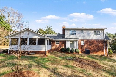 Welcome to this spacious 4-sided brick home with painted cedar
