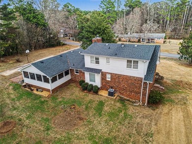 Welcome to this spacious 4-sided brick home with painted cedar