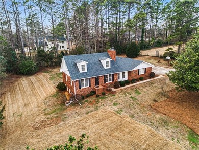 Welcome to this spacious 4-sided brick home with painted cedar
