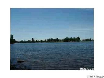 Build your dream home on this secluded deep lot with 150 feet of - Lake Acreage For Sale in Three Mile Bay, New York