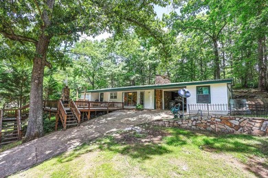 Enjoy seasonal views of Lake Greeson from this 3-bedroom, 2-bath - photo 1